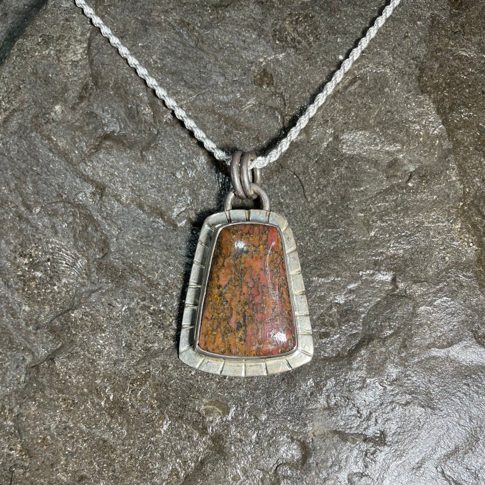 Dinosaur gem bone pendant