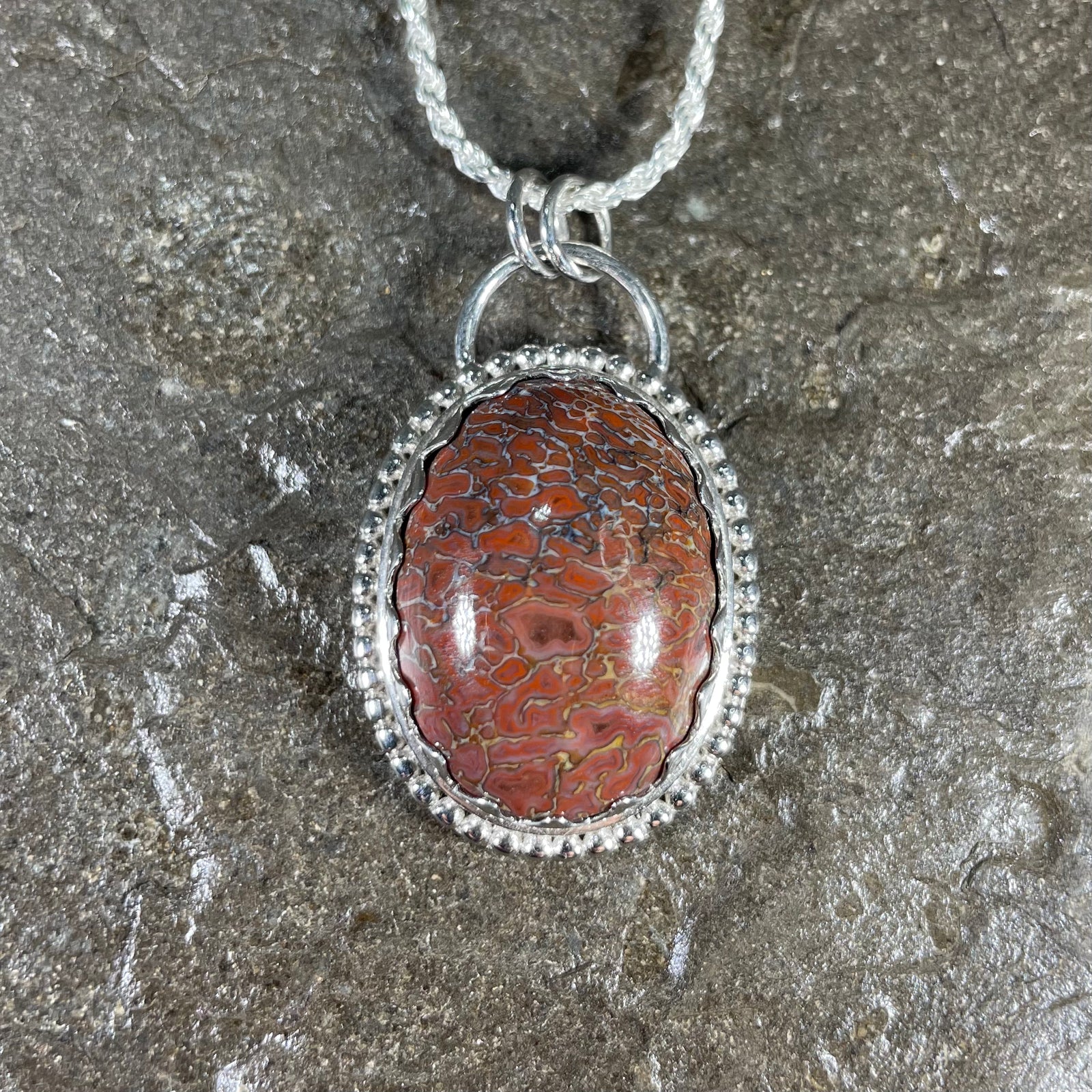 Dinosaur gem bone pendant