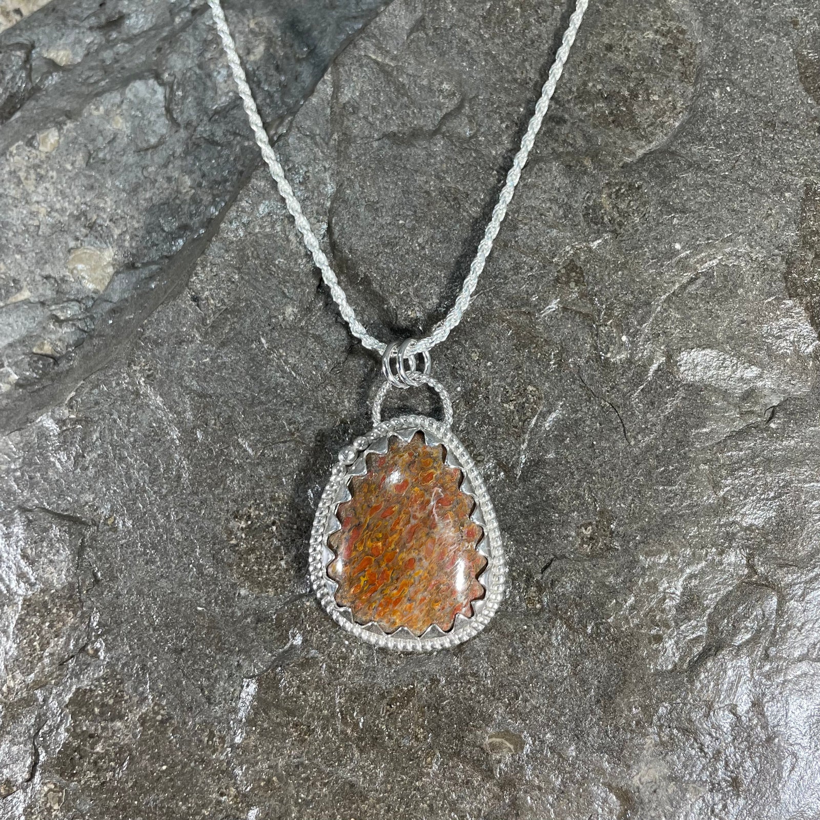 Dinosaur gem bone pendant