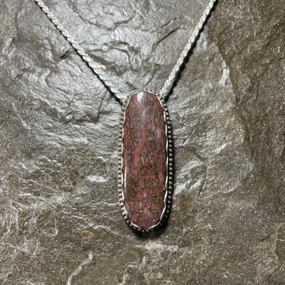Dinosaur gem bone pendant