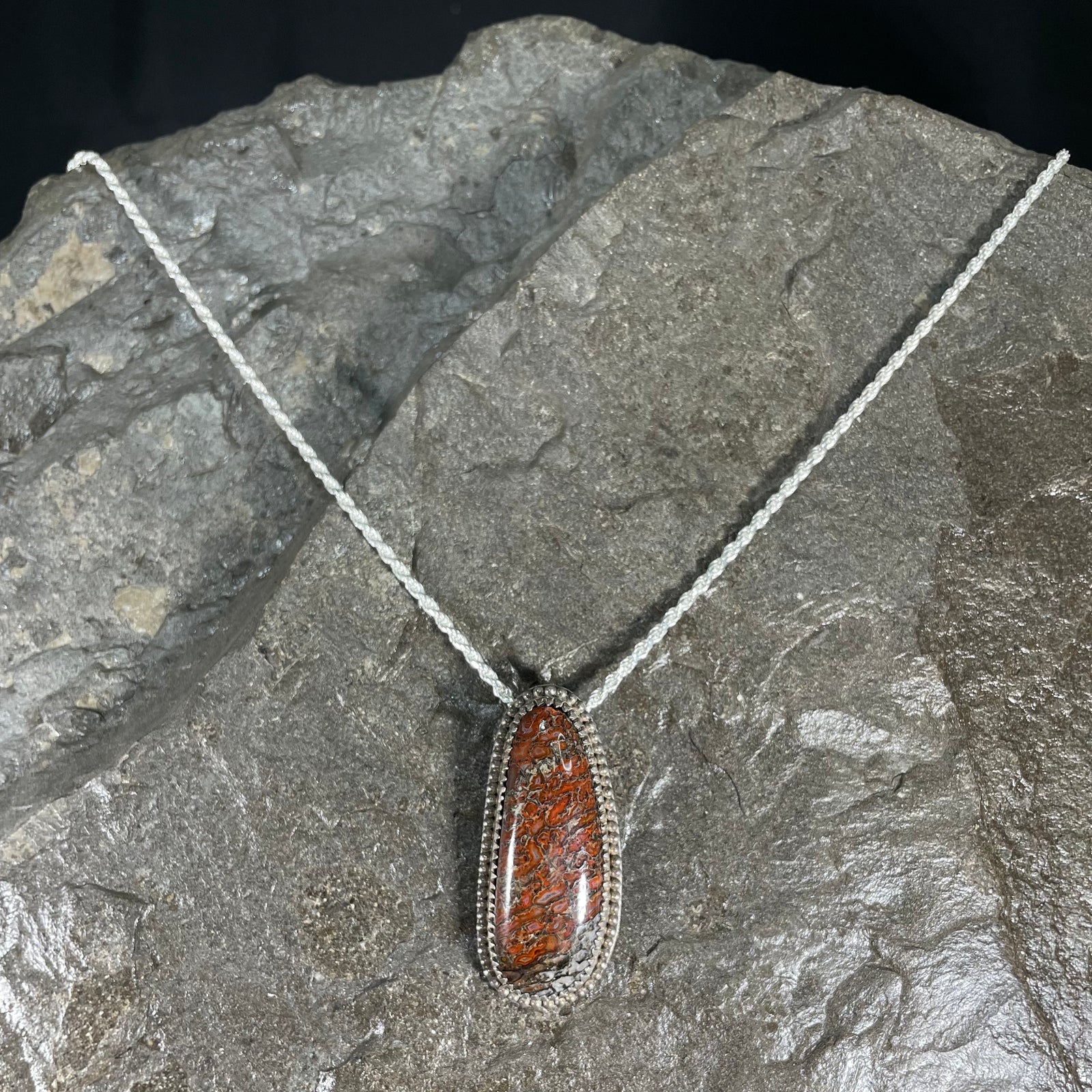 Dinosaur gem bone pendant