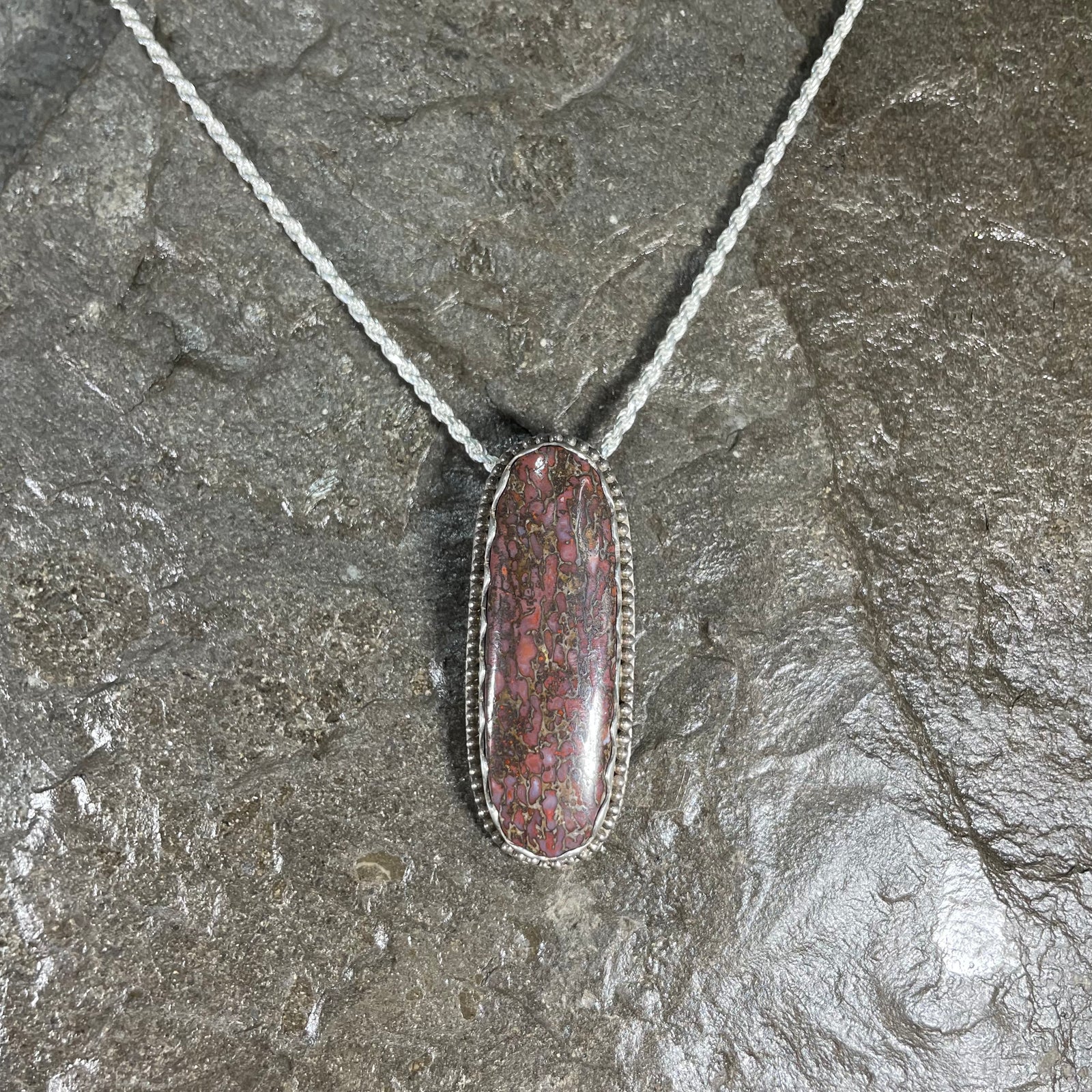 Dinosaur gem bone pendant