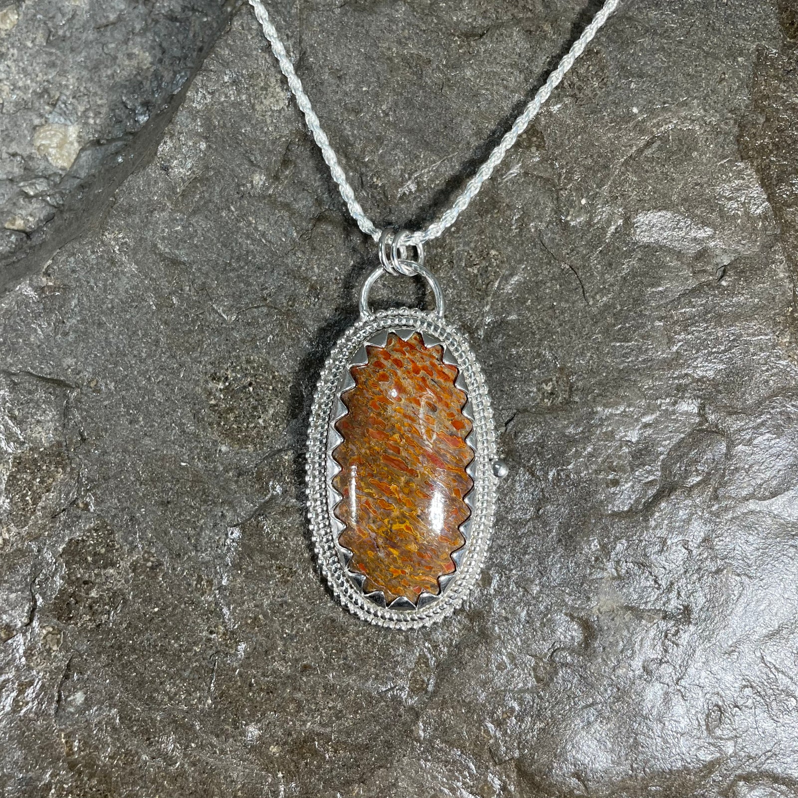 Dinosaur gem bone pendant