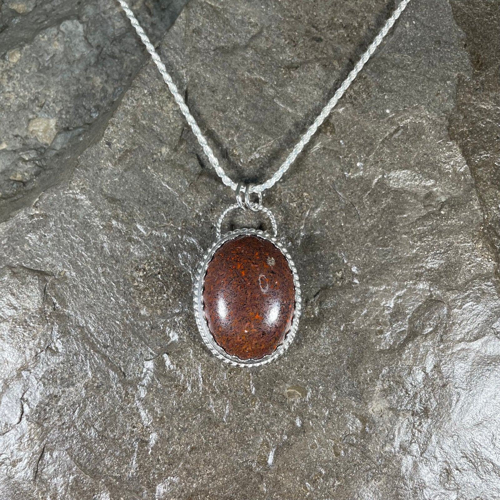 Dinosaur gem bone pendant